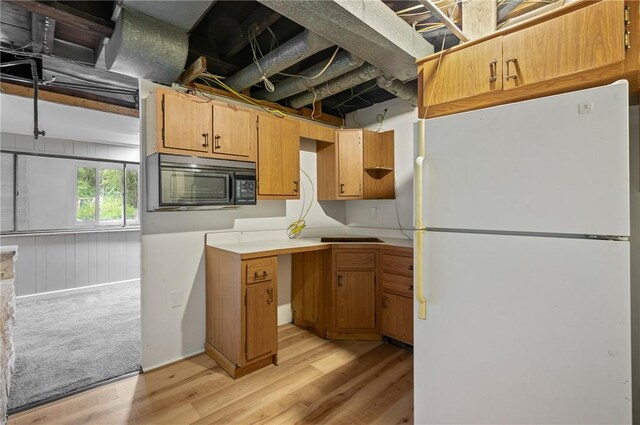 kitchen featuring light hardwood / wood-style floors and white fridge