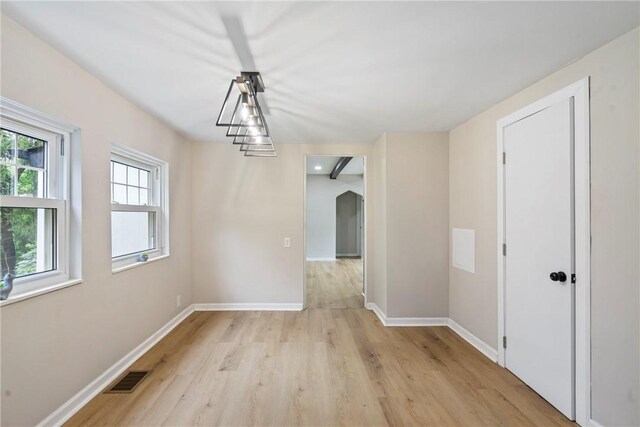 unfurnished dining area with light wood-type flooring