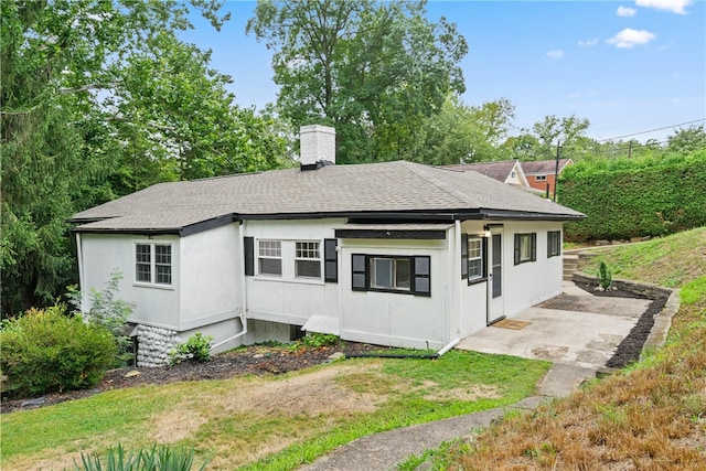 rear view of property with a lawn