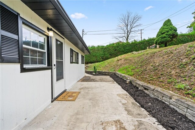 view of side of home featuring a patio area