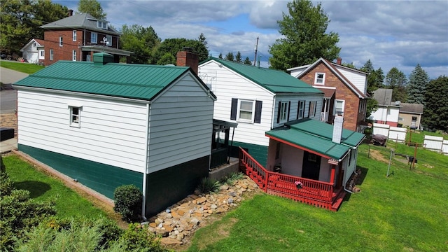 rear view of property featuring a yard