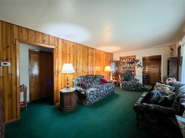 living room featuring wooden walls and dark colored carpet