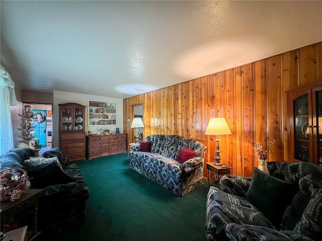 carpeted living room featuring wood walls