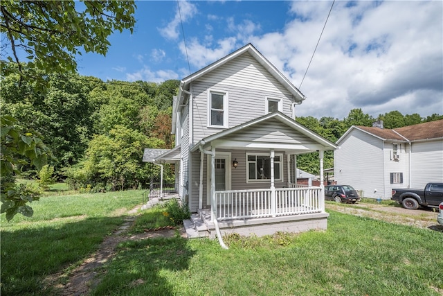 view of front of property with a front yard and covered porch