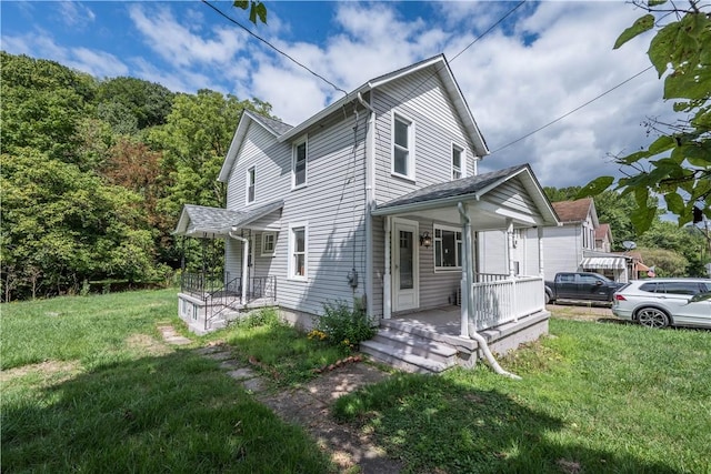 view of home's exterior featuring covered porch, a yard, and a garage