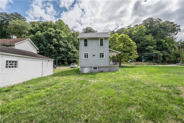 back of house with a lawn