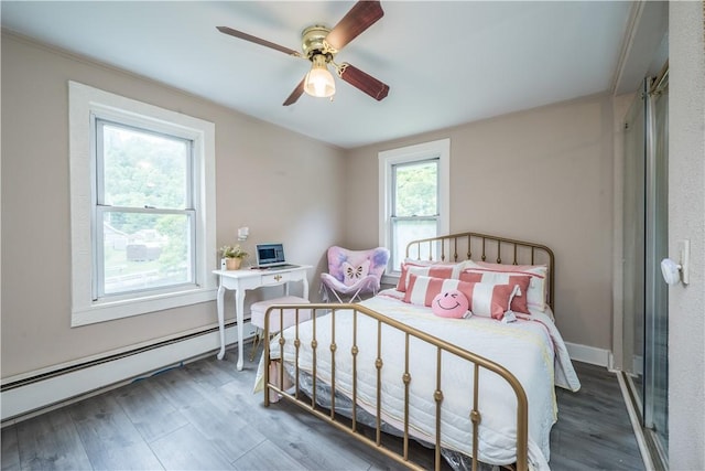 bedroom featuring a baseboard heating unit, ceiling fan, baseboards, and wood finished floors