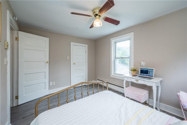 bedroom featuring baseboards, a baseboard heating unit, ceiling fan, and wood finished floors