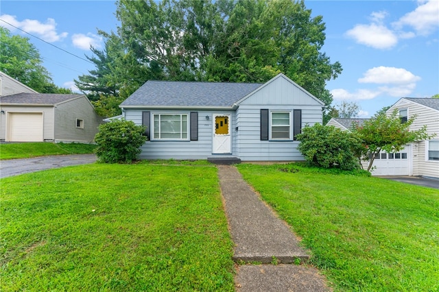 view of front of house with a garage and a front lawn