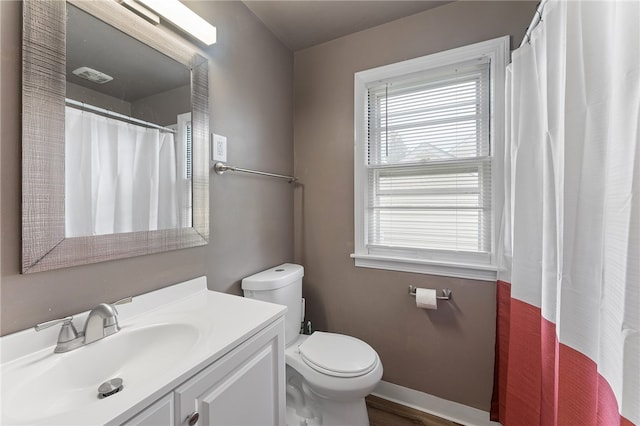 bathroom with toilet, hardwood / wood-style flooring, and vanity