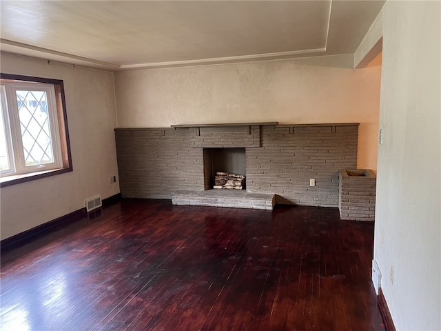 unfurnished living room with a fireplace and dark hardwood / wood-style floors