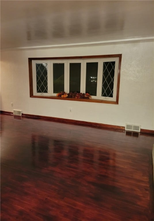 spare room with dark hardwood / wood-style floors