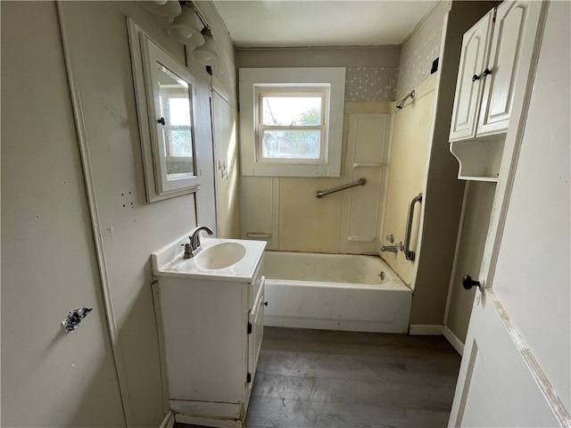 bathroom with hardwood / wood-style floors, bathtub / shower combination, and vanity