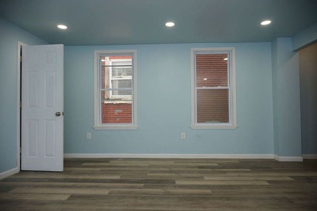 spare room featuring dark wood-type flooring