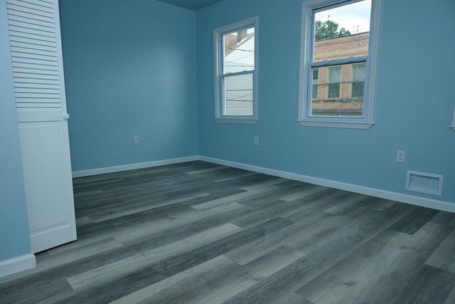 spare room with dark hardwood / wood-style flooring