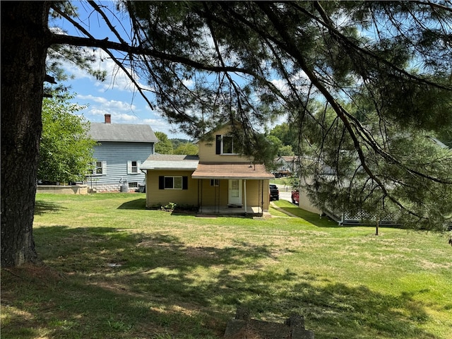 rear view of house with a lawn