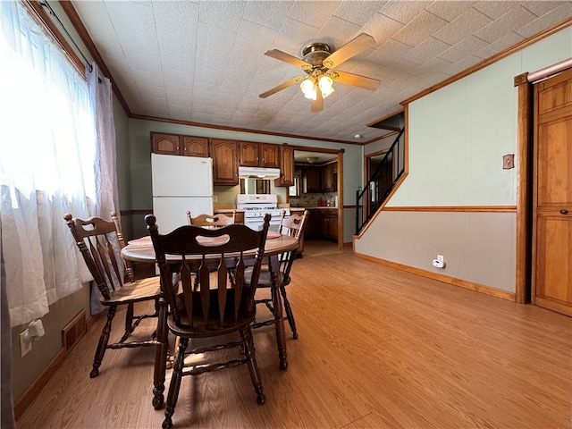 dining space featuring ceiling fan, light hardwood / wood-style flooring, and ornamental molding