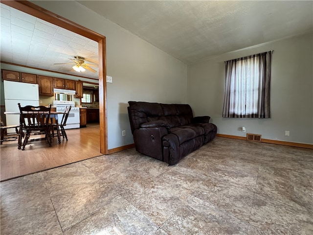 living room featuring light tile patterned flooring and ceiling fan