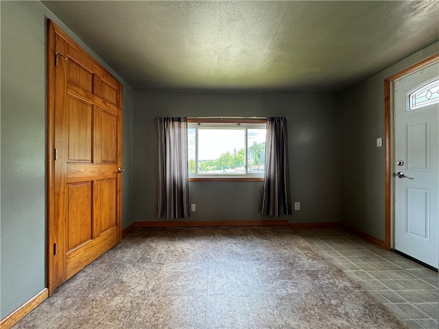 tiled entrance foyer with a textured ceiling