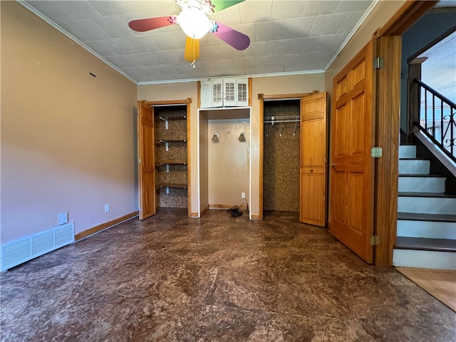 unfurnished bedroom with ceiling fan, dark tile patterned flooring, and ornamental molding