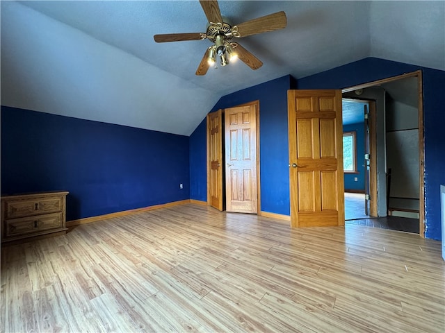 additional living space featuring light wood-type flooring, ceiling fan, and lofted ceiling