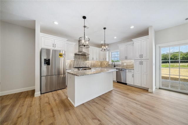 kitchen featuring stainless steel appliances, plenty of natural light, white cabinetry, and a kitchen island