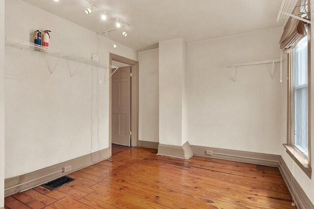 unfurnished room featuring light hardwood / wood-style floors and track lighting