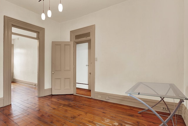 spare room with wood-type flooring