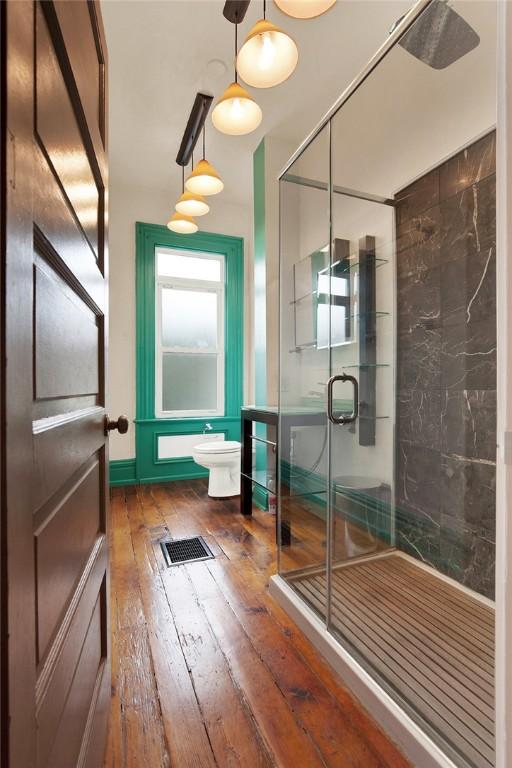 bathroom featuring toilet and hardwood / wood-style flooring