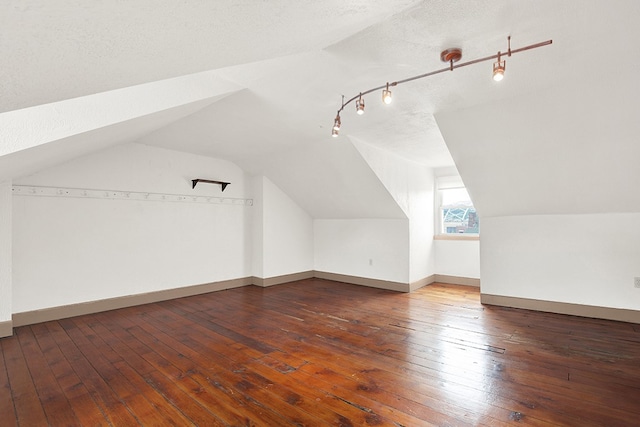 bonus room featuring a textured ceiling, vaulted ceiling, and hardwood / wood-style flooring