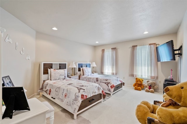 bedroom featuring a textured ceiling and light carpet