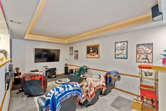 interior space featuring a raised ceiling and light tile patterned flooring