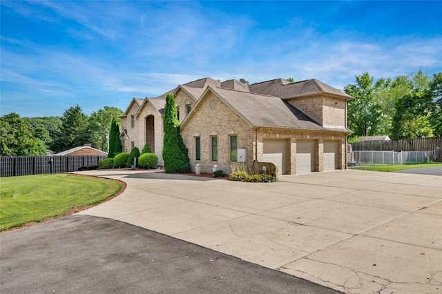 view of front of house featuring a front yard and a garage