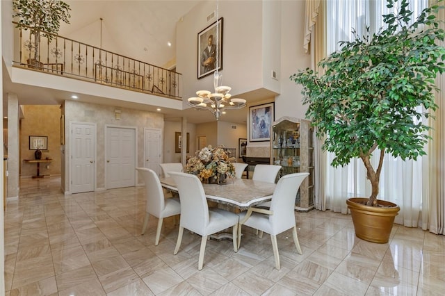 dining room featuring a high ceiling, an inviting chandelier, and light tile patterned floors