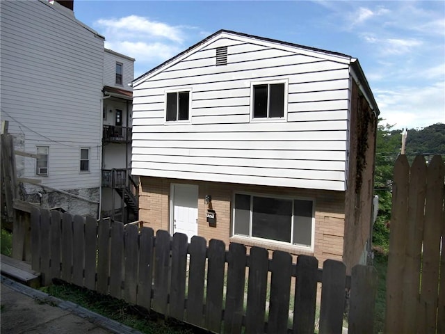 view of front of home with fence and brick siding