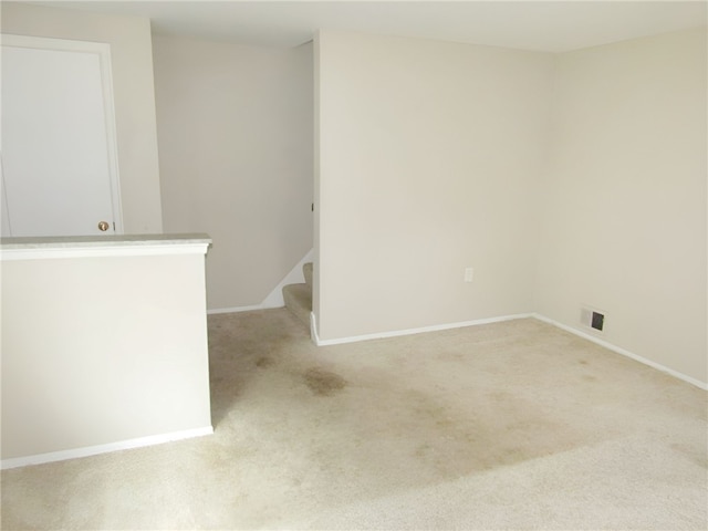 unfurnished room with light carpet