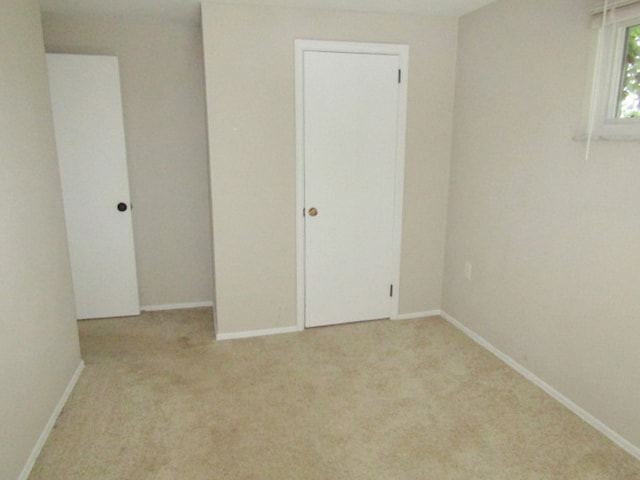 spare room with light carpet