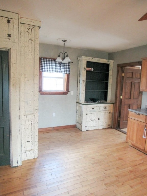 interior space featuring light hardwood / wood-style floors and a chandelier