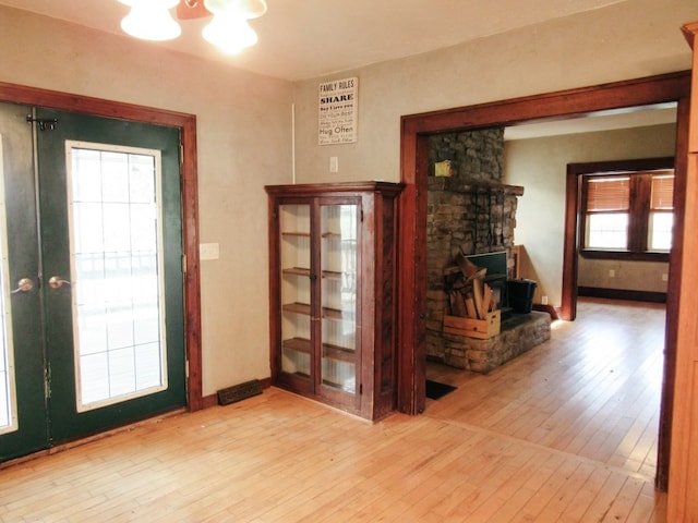 entryway featuring light wood-type flooring and french doors