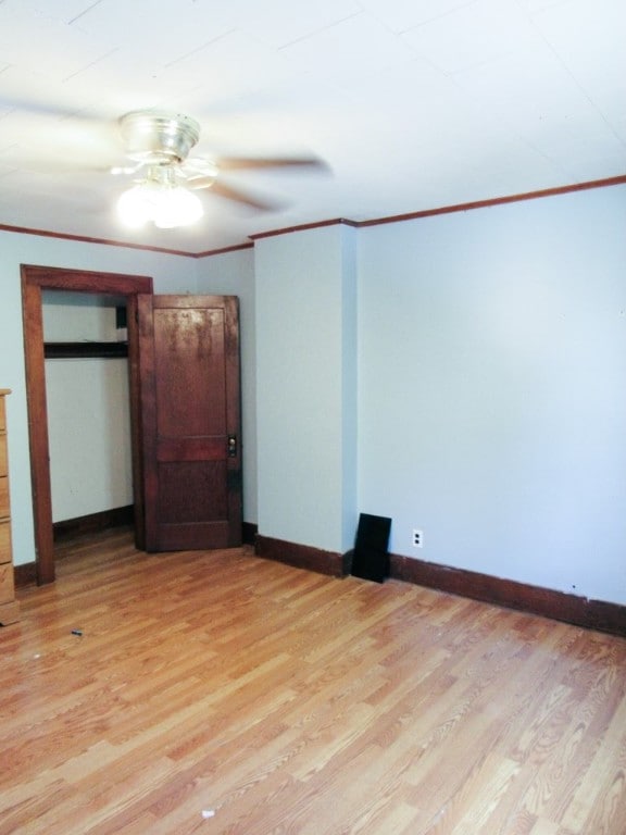 unfurnished bedroom with ceiling fan, light hardwood / wood-style floors, and crown molding