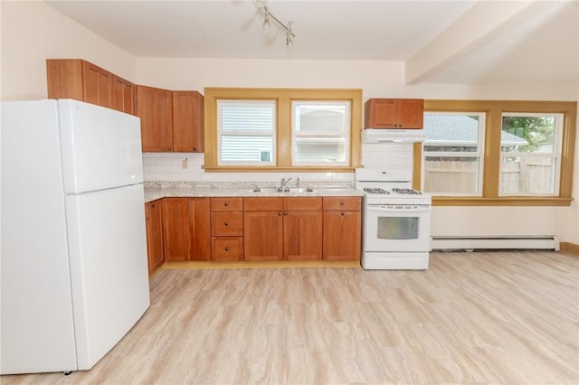 kitchen featuring a baseboard radiator, under cabinet range hood, white appliances, a sink, and decorative backsplash