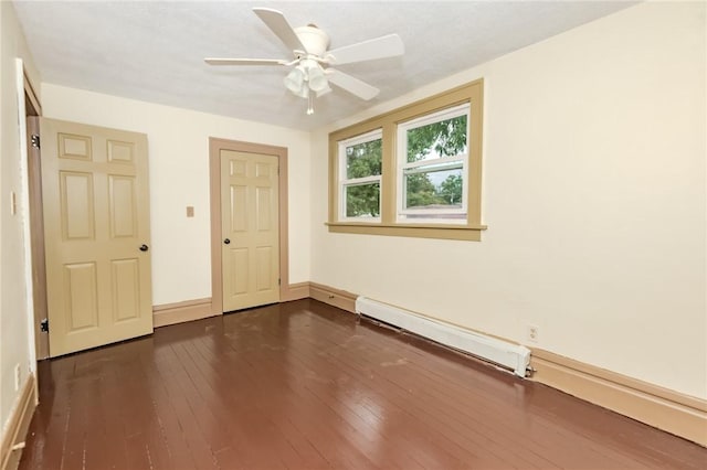 unfurnished bedroom with dark wood-style floors, a baseboard radiator, ceiling fan, and baseboards