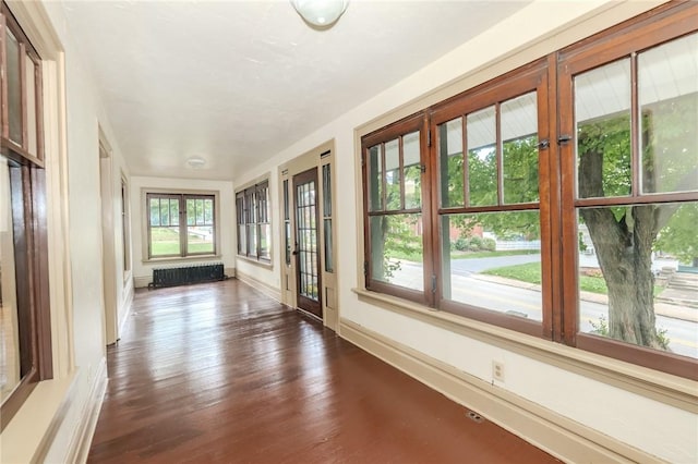 unfurnished sunroom with radiator heating unit