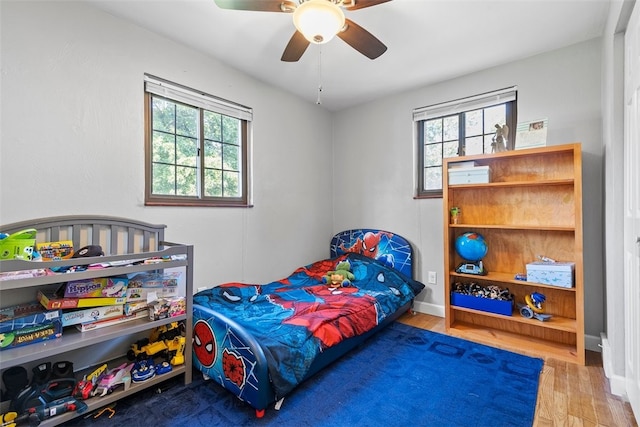 bedroom with hardwood / wood-style flooring and ceiling fan