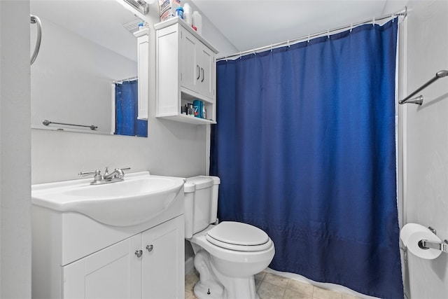 bathroom featuring tile patterned floors, vanity, and toilet