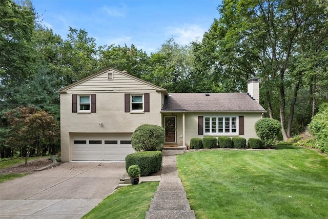 split level home featuring a garage and a front yard