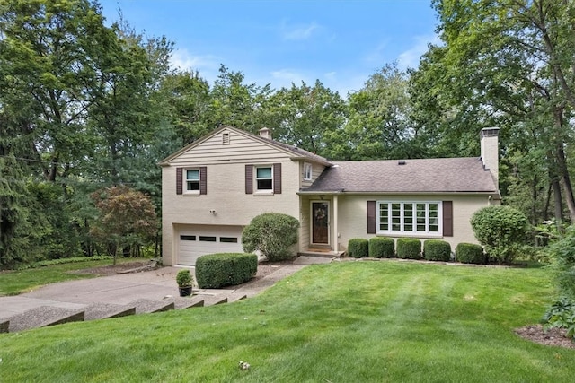 split level home with a garage and a front yard