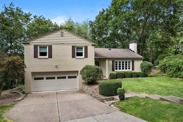 tri-level home featuring a garage and a front yard