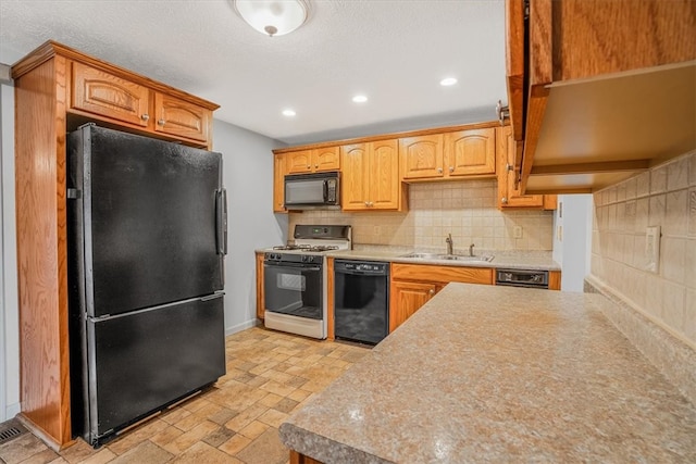 kitchen with sink, black appliances, and backsplash