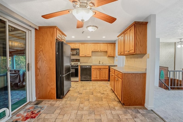 kitchen with backsplash, a textured ceiling, black appliances, and sink